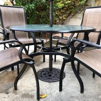 Lot 3. Patio table (44â€™ round) with four chairs--$55
