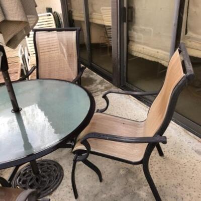 Lot 3. Patio table (44â€™ round) with four chairs--$55