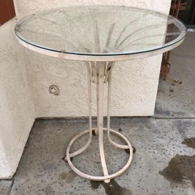 Lot 6. Iron tall outdoor glass-top iron table (36â€ x 30â€)--$35 