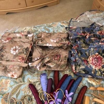 Lot 14. Four floral garment bags (3 unused) with matching carry-ons and assorted hangers--$85