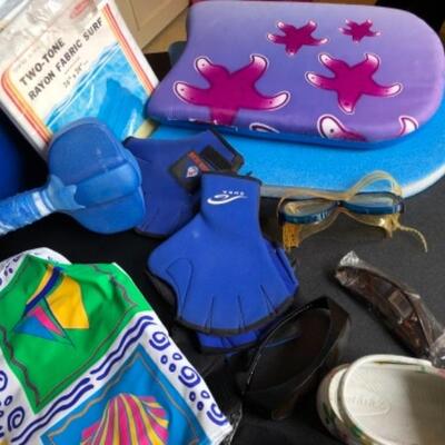 Lot 22. Assortment of swimming apparel, beach bags, croc shoes, kidâ€™s kickboard, two floats, coolers, three pairs hydro gloves, two...