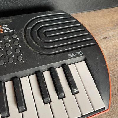 G25: Casio SA-76 Electronic Keyboard and Samson HP30 Headphones