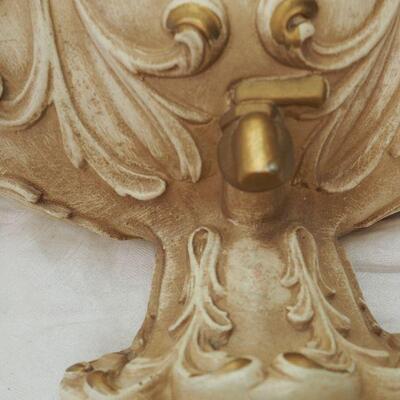 Lot 13 Plaster Faux wall fountain hangs on wall