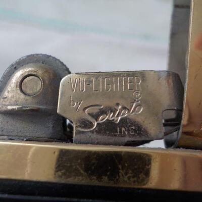 Scripto vu-lighter with gold trim.