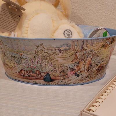 Lot 40: New Baby Book, Ribbon, Patricia Reach Musical Ornament, Peek-a-Boo Bunny and vintage Peter Rabbit Tin