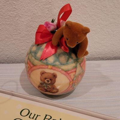 Lot 40: New Baby Book, Ribbon, Patricia Reach Musical Ornament, Peek-a-Boo Bunny and vintage Peter Rabbit Tin