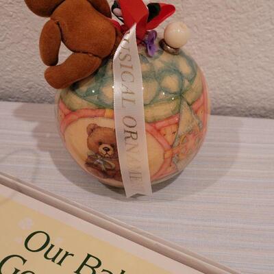 Lot 40: New Baby Book, Ribbon, Patricia Reach Musical Ornament, Peek-a-Boo Bunny and vintage Peter Rabbit Tin