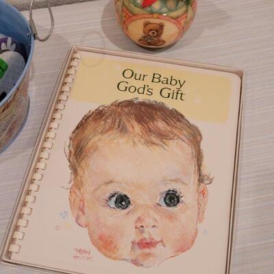 Lot 40: New Baby Book, Ribbon, Patricia Reach Musical Ornament, Peek-a-Boo Bunny and vintage Peter Rabbit Tin