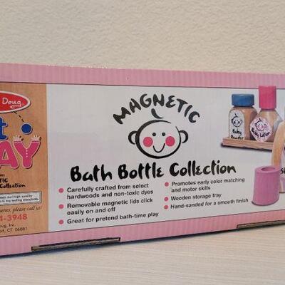 Lot 186: Melissa & Doug NEW Magnetic Bath Bottle Collection + New Elmo Clip On Giggle Toy
