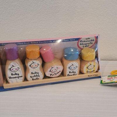 Lot 186: Melissa & Doug NEW Magnetic Bath Bottle Collection + New Elmo Clip On Giggle Toy