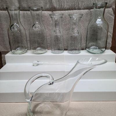 7 pc collection. 5 Paul Masson Wine Carafes, one wine decanter, and one glass stirrer