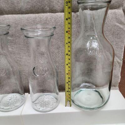 7 pc collection. 5 Paul Masson Wine Carafes, one wine decanter, and one glass stirrer