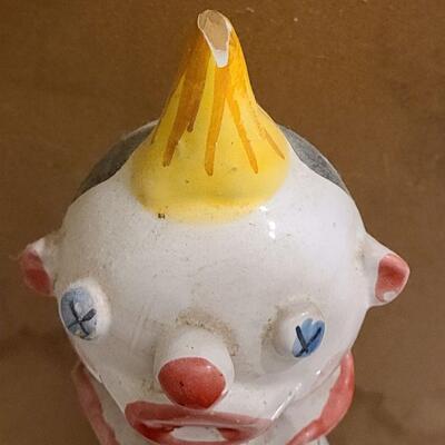 13 pc. Vintage clown collection with white wicker shelf.