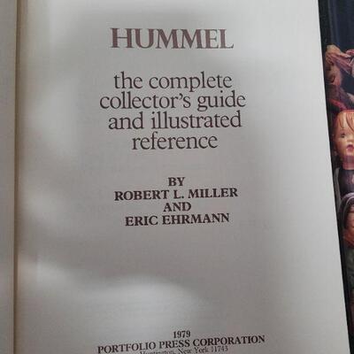 LOT# 71 TWO Hummel Collector's Books, TWO Necklaces, a Plaque, and a Stand. 