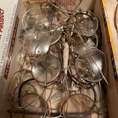 Cigar box full of antique spectacles  