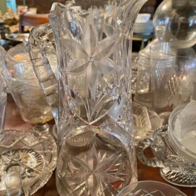 Lot 24DR. Collection of crystal and glass vases, decanters, flower frogs, salt/pepper shakers, ring dish, ice bucket, pitcher, etc.--$130