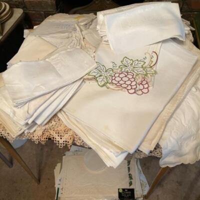 Lot 25DR. Assorted linens, tablecloths, damask napkins, paper doilies, placemats, etc.â€”$110