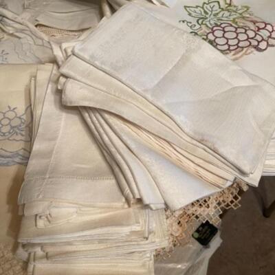 Lot 25DR. Assorted linens, tablecloths, damask napkins, paper doilies, placemats, etc.â€”$110