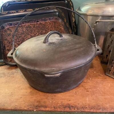 Lot 75K. Assortment of pots, pans, trays, pressure cooker, Dutch oven (Wagner Ware)--$85