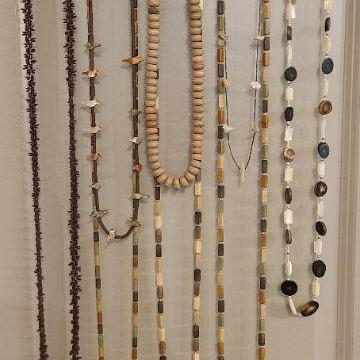 8 assorted necklaces in brown tones. 