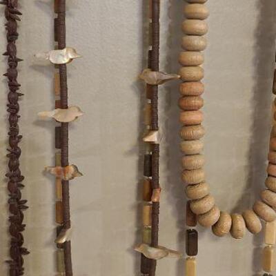 8 assorted necklaces in brown tones. 