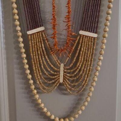 3 necklace lot. Wood bead, coral, and multi strand bead in brown tones. 
