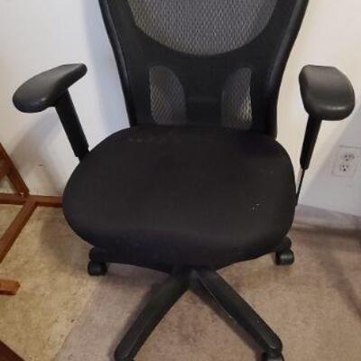 Black rolling, swivel, 5 wheel, office chair with adjustable seat and arm rest height. 