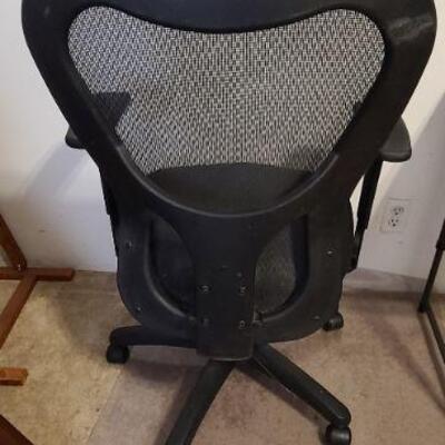 Black rolling, swivel, 5 wheel, office chair with adjustable seat and arm rest height. 