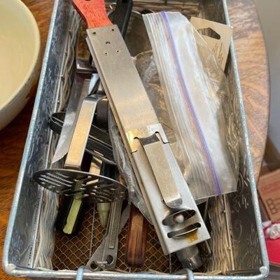 Bin of vintage kitchen utensils 