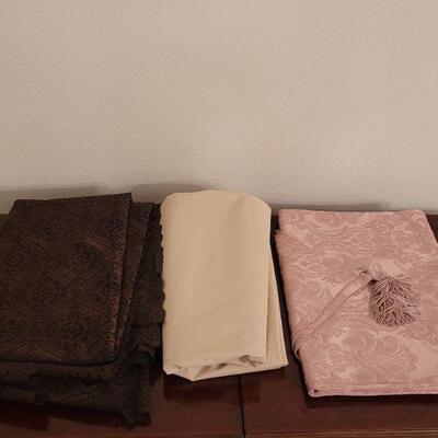 Lot 130:  Brown Lace, Pink Runner and Plastic Tablecloths 
