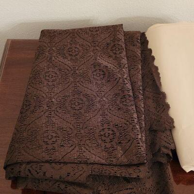 Lot 130:  Brown Lace, Pink Runner and Plastic Tablecloths 