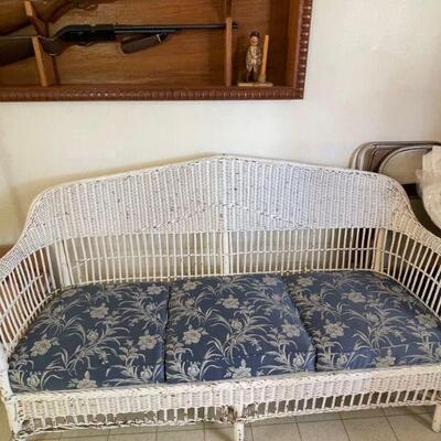 White wicker couch / blue cushions 
