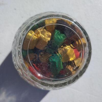 Vintage jar with wooden game pieces