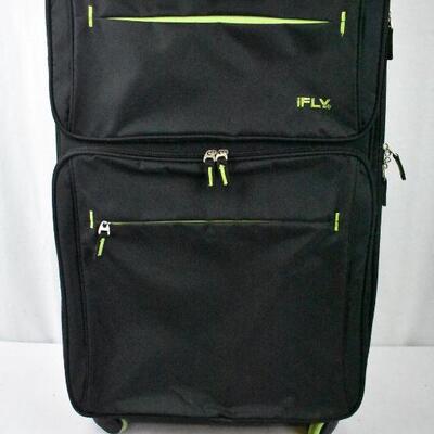 iFLY Suitcase, Black with Green accents. 4 spinner wheels, 1 wheel shows damage