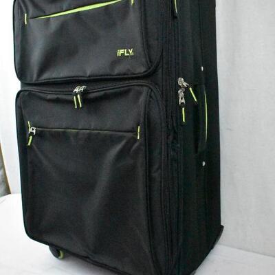 iFLY Suitcase, Black with Green accents. 4 spinner wheels, 1 wheel shows damage