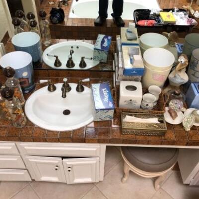 Lot 18. Four bath waste baskets, 3 tissue holders, tissue, night lights, soap, powder jars, decorative bottles, soap dish, etc.--WAS...