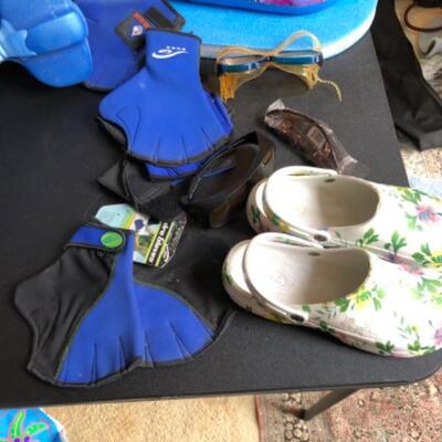 Lot 22. Assortment of swimming apparel, beach bags, croc shoes, kid’s kickboard, two floats, coolers, three pairs hydro gloves, two sets...