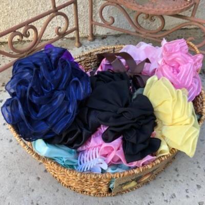 Lot 24. Large assortment of hair flowers, 6 sunhats, 2 sarongs, one strapless sun dress (Tommy Bahama), pool and beach bags, two...