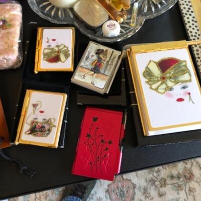 Lot 27. Three figurines, paper dolls, pictures, bunny, alarm clocks, trinket boxes, gloves, notepads/pens, perfumes, ornaments, sewing...