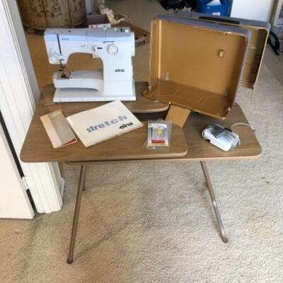 Lot 40. Elna sewing machine in original box with foot pedal and folding table--WAS $125â€“NOW $93.75