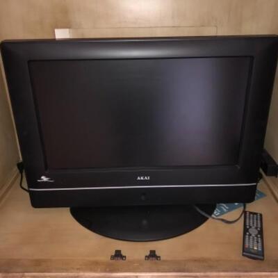 Lot 47. Hand painted wooden television cabinet (78â€H x 46â€W x 25â€D) with AKAI 26â€ television with remote and manual--WAS...