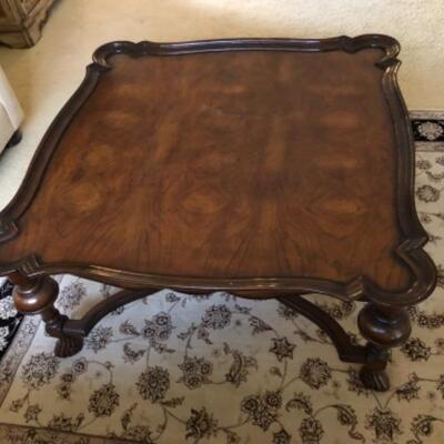 Lot 48. Wooden coffee table 42â€ square 20â€ high in walnut--WAS $65â€“NOW $48.75