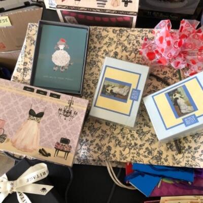 Lot 79. Lot of new notepads, boxes, gift  wrap, ribbon tags, gift  bags, Santa figure, two baskets, etc.--WAS $55â€“NOW $41.25