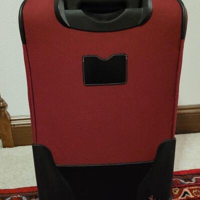 Lot 890: Omnidirectional Red Luggage 