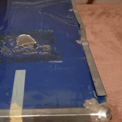 Lot 910: Vintage Blue Metal Trunk (has some damage from travel)