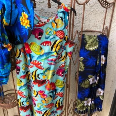 Lot 23. Twenty-two size large womenâ€™s bathing suits, two mumus, cover-up, vacation lounge wear, foldable sun hats, etc.--WAS $145â€“NOW...