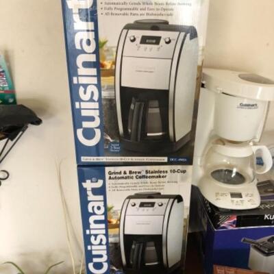 Lot 84. Two new Cuisinart coffee makers still boxed, used white Cuisinart pot, deep fryer, fountains, dip chillers, Hawaiian mugs, space...
