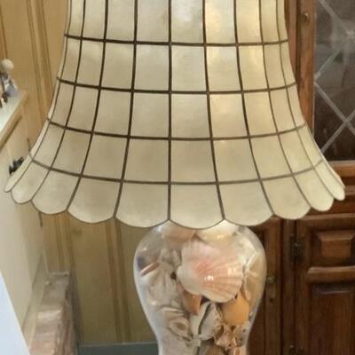 2040 Clear Glass Lamp Filled With Seashells and Capize Lampshade