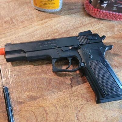 Airsoft spring load pistol and 2 mostly full jars of BB's