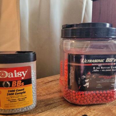 Airsoft spring load pistol and 2 mostly full jars of BB's